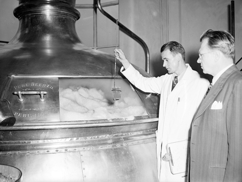 Peller Workers Examining Machine